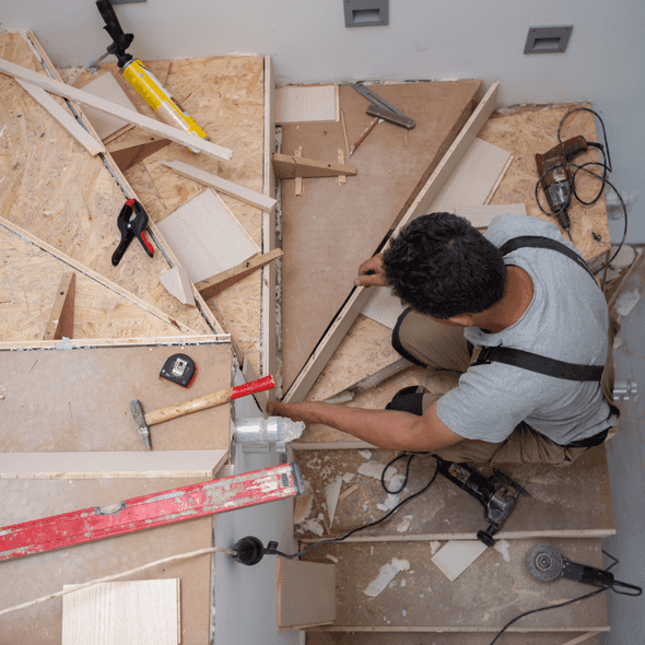 About Us carpenter installing stairs aerial view