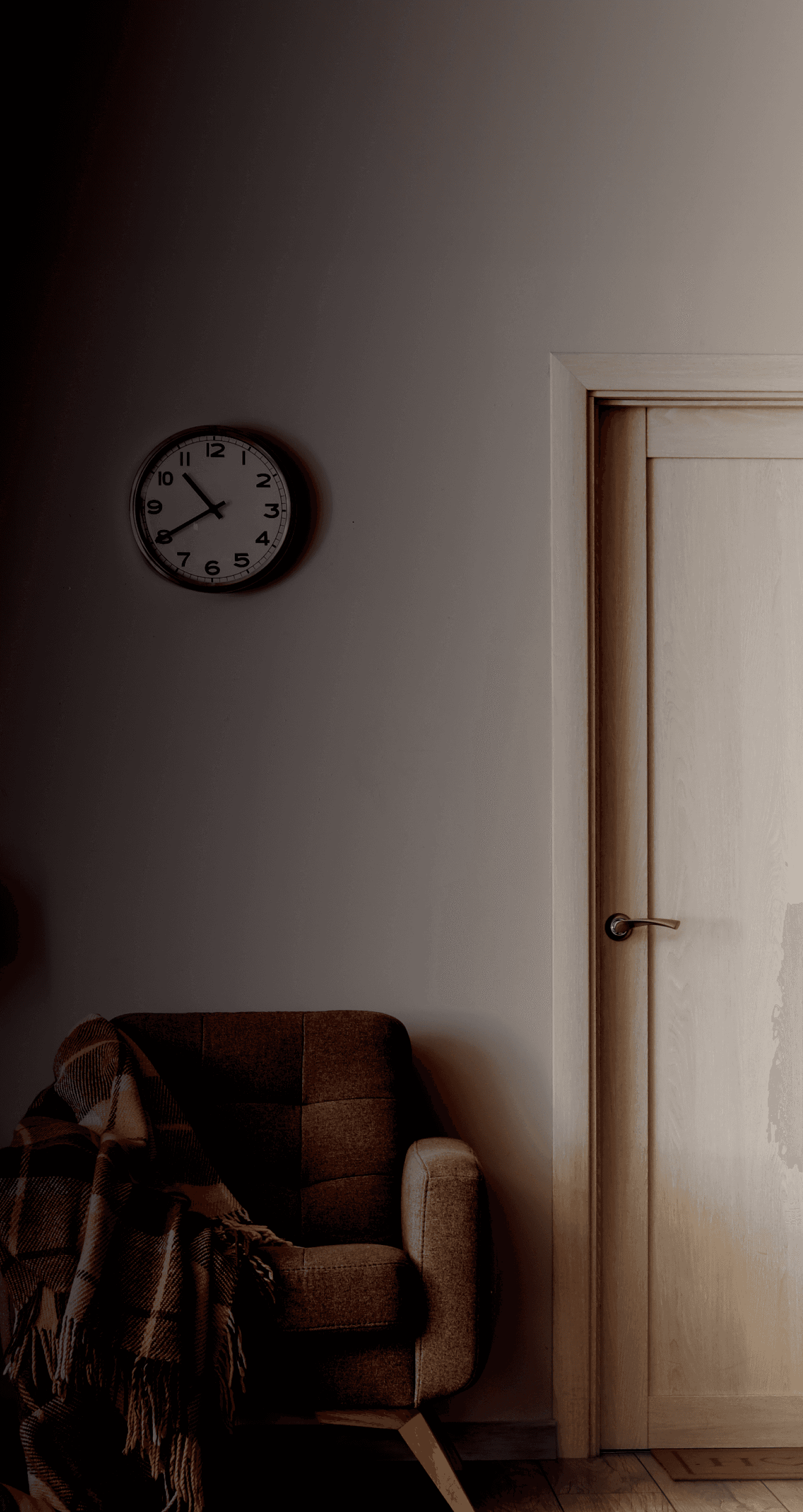 lamp and chair beside white door